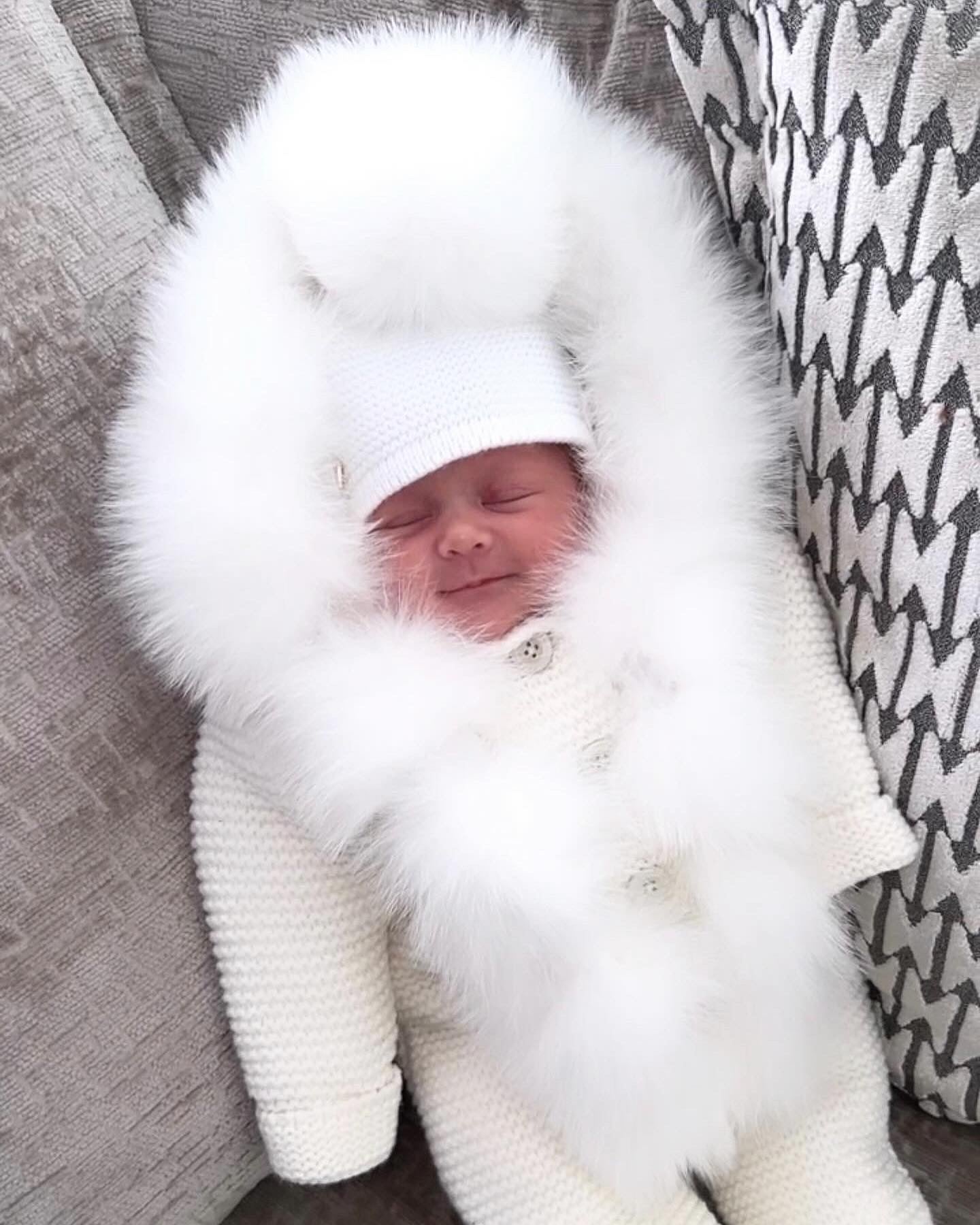 MI LOVES SIGNATURE Cream Knitted Pramsuit with Luxurious Fox fur trim.