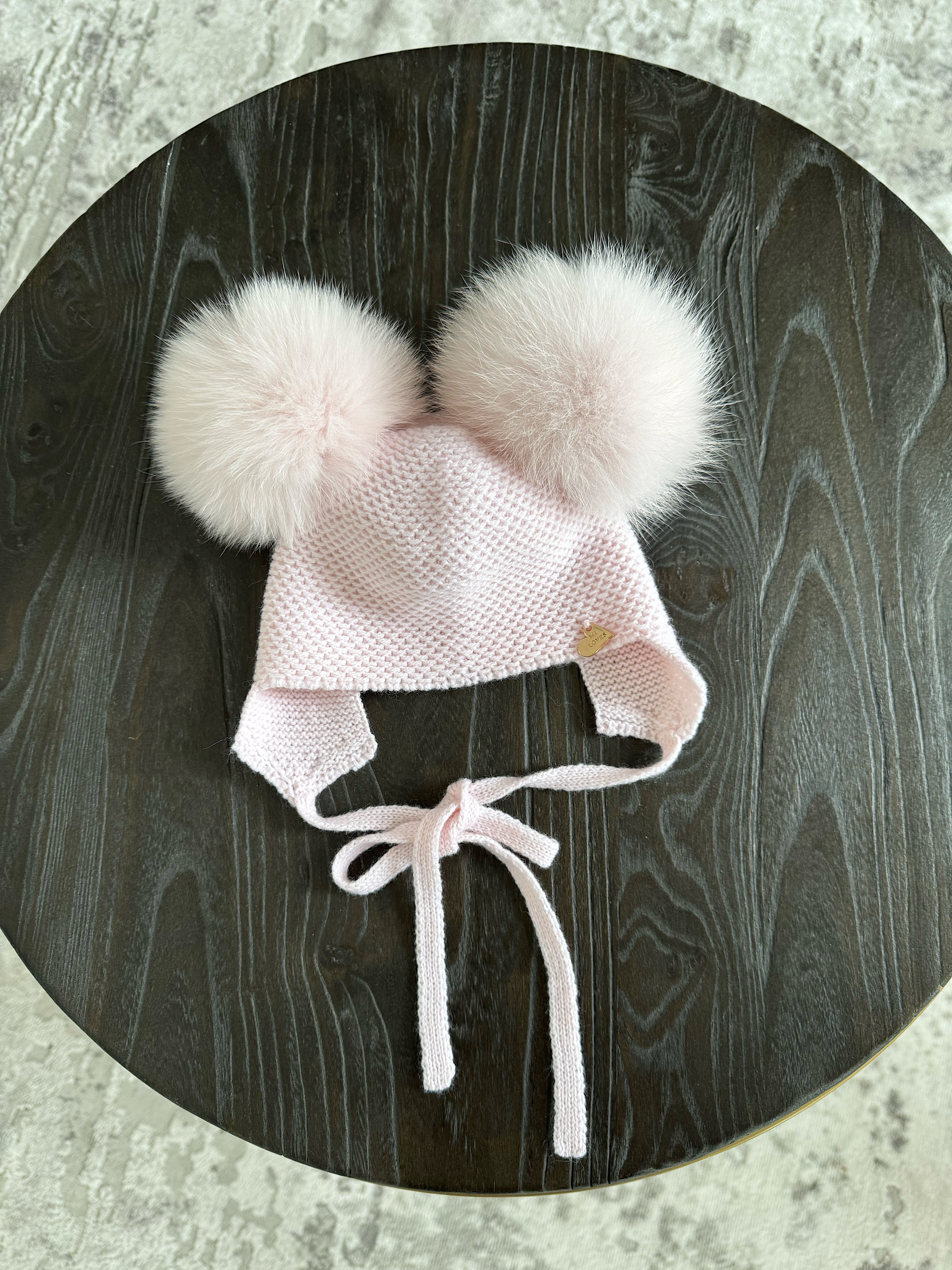 Knitted Double pompom hat .