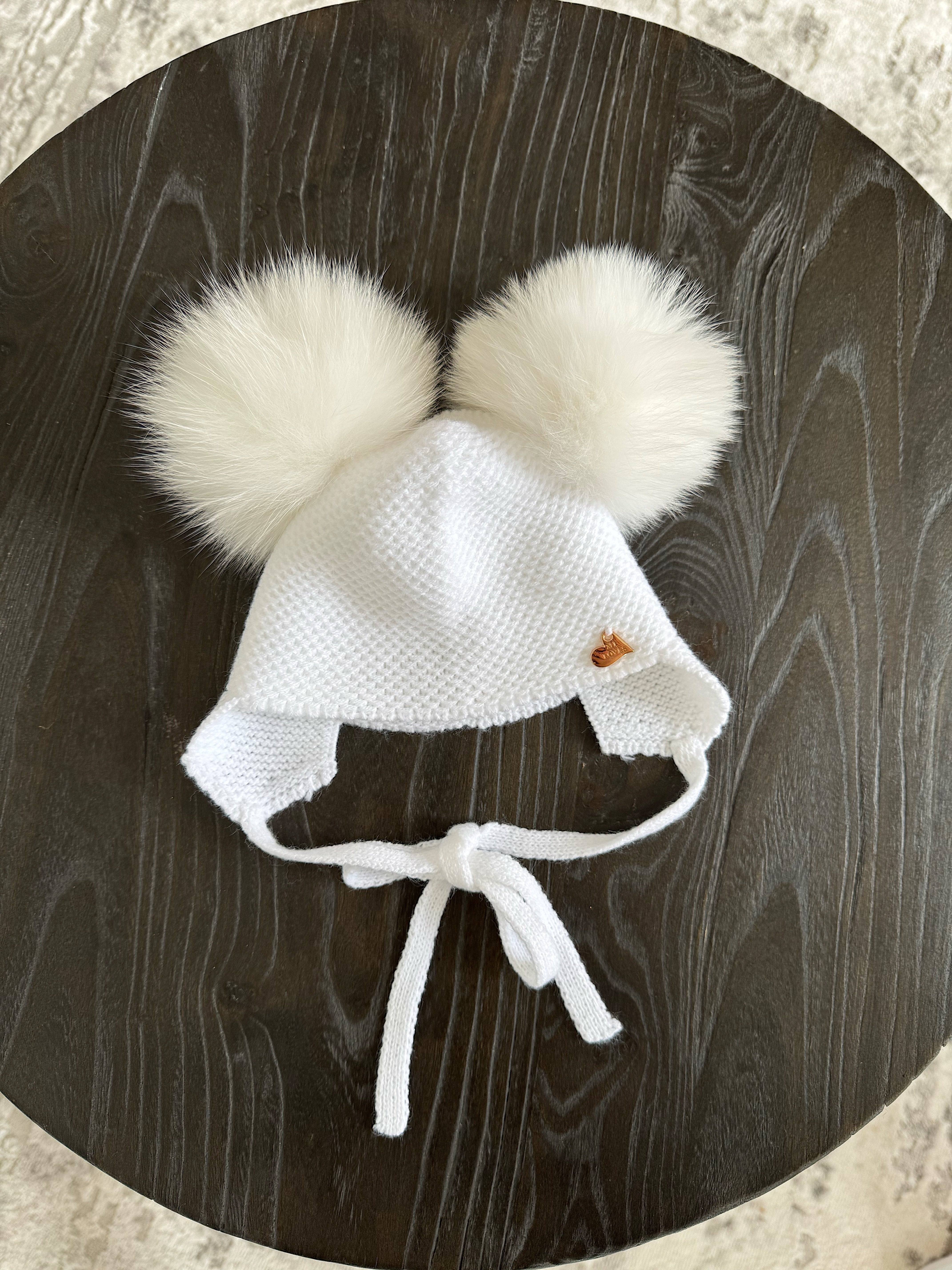 Knitted Double pompom hat .